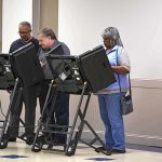 Lester Bowie and Miriam Tlali using electronic voting machines at a polling place