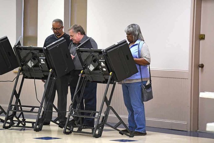 shutterstock_512226370 Lester Bowie and Miriam Tlali using electronic voting machines at a polling place