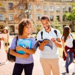 College Value Hits 48-Year LOW College students walking on campus with books and backpacks