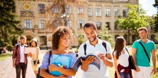 College students walking on campus with books and backpacks